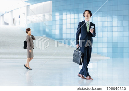 A young businessman looking at a smartphone A young businessman looking at a smartphone 106049810