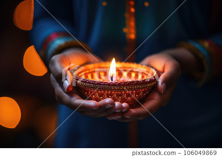 Diwali Hindu Festival of lights celebration. Diya oil lamp lit in woman hands. AI generated 106049869