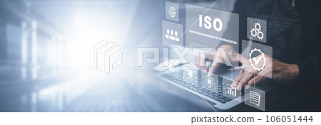 Hand hold Laptop with ISO standards quality control concept, assurance warranty in dark background, Cogs and gear wheel mechanisms, identification information security and encryption, secure access 106051444
