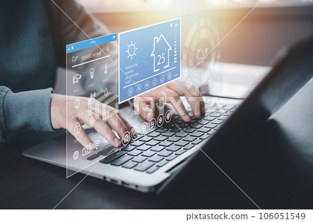 Hand using AI smart tablet with smart home app on the room, circular interface of the smart home automation assistant on the virtual screen and user touches the button, smart home digital interface 106051549