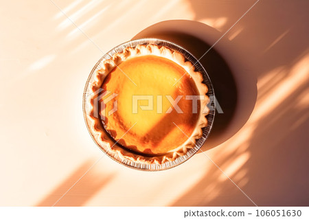 Festive homemade appetizing ripe pumpkin pie, pumpkin tart decorated with nuts, minimalistic light background 106051630