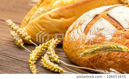 Concept of abundance and harvest, bread and ears of wheat. 106051655