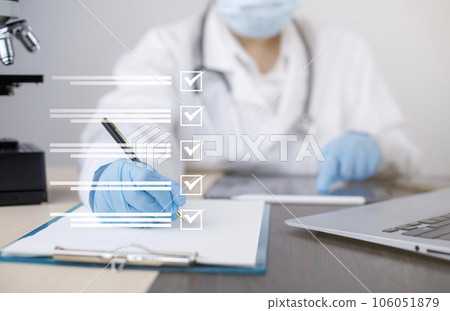 Female Doctor using Taking an assessment, questionnaire, evaluation, online survey, Prescription or signing medical report or medical certificate or health check-up form documents in hospitals. 106051879