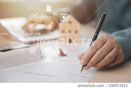 US IRS 1040 form or  US Individual income tax Concept,accountant holding pen working on calculator business with data accounting documents and a laptop, pay tax in 2023 years,new year 2023 tax concept 106051912