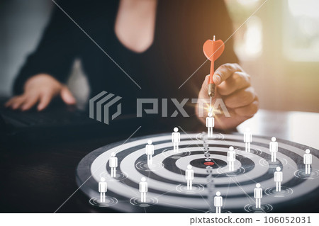 Targeting with Human team icon business concept, Businesswoman hand holding red dart to the virtual target dartboard, Executive marketing, investment goal and target for business investment concept, 106052031
