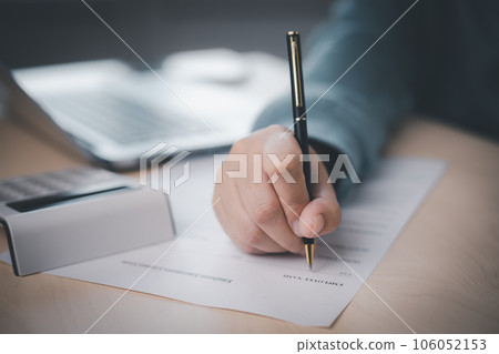 US IRS 1040 form or  US Individual income tax Concept,accountant holding pen working on calculator business with data accounting documents and a laptop, pay tax in 2023 years,new year 2023 tax concept 106052153