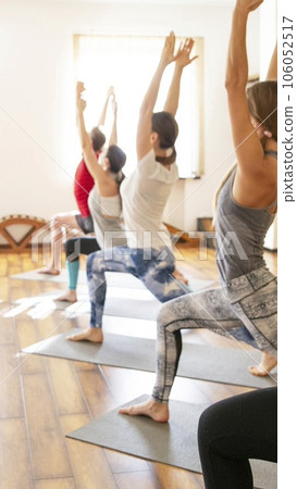 Yoga Class, Group of People Relaxing and Doing Yoga pose. Wellness and Healthy Lifestyle. 106052517