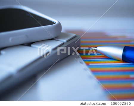 Keyboard, graph and smartphone on the table Keyboard, graph and smartphone on the table 106052850