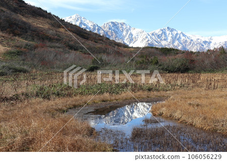 Shirouma Sanzan reflected in a wetland pond in late autumn 106056229