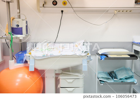 Neonatal incubator and weights for newborn baby, part of medical equipment of delivery room in the maternity hospital Neonatal incubator and weights for newborn baby, part of medical equipment of delivery room in the maternity hospital 106056473