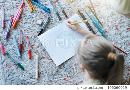 Child girl drawing with colorful pencils Child girl drawing with colorful pencils 106060019