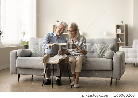 Happy senior married couple taking photo album 106060206