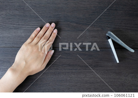 Young woman's hands and nail clippers Young woman's hands and nail clippers 106061121