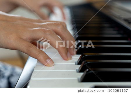 Young woman's hand playing the electronic piano Young woman's hand playing the electronic piano 106061167