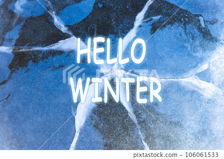 Winter background. Hello Winter lettering inscription. Abstract ice background. Blue background with cracks on the ice surface. 106061533