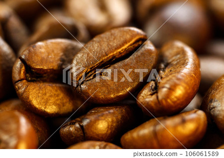 Dark brown roasted coffee is spinning. Coffee product advertising concept. Close up, macro. Selective Focus. Dark brown roasted coffee is spinning. Coffee product advertising concept. Close up, macro. Selective Focus. 106061589