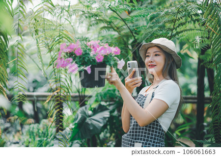 Young women doing hobbies taking care of plants, watering, shoveling flowers. In the garden during the break from work 106061663