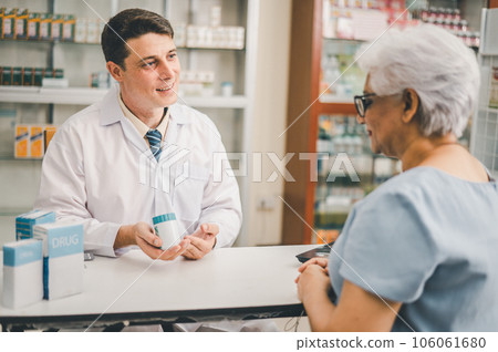 Pharmacist giving advice And advice for patients who come to buy Medicine, Drugs, Vitamins products, according to prescriptions in modern pharmacies. Pharmacist giving advice And advice for patients who come to buy Medicine, Drugs, Vitamins products, according to prescriptions in modern pharmacies. 106061680