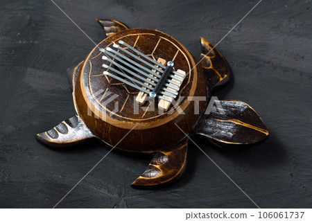 Kalimba turtle on a black background. Traditional instrument from Africa in close-up. 106061737