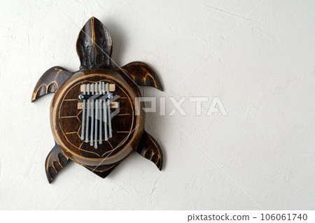 Kalimba turtle .Traditional Kalimba made from wooden board with metal, play on hands. Copy space 106061740