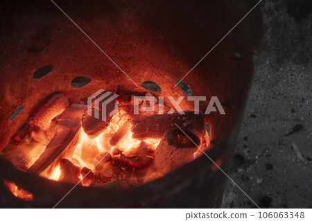 Bonfire and burning charcoal at the campsite Bonfire and burning charcoal at the campsite 106063348