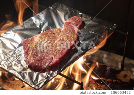 Steak cooked over an open fire while camping Steak cooked over an open fire while camping 106063432
