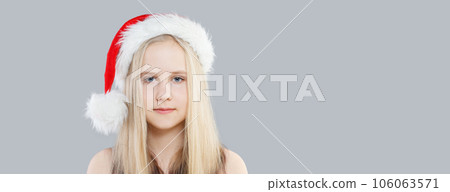 Cute young girl Santa on gray background, Christmas portrait 106063571