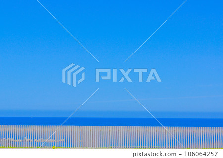 Blue sky and sand barrier 106064257