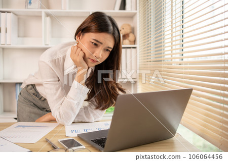 Stressed Young Businesswoman Facing Financial Loss in Corporate Office, Depressed man Dealing with Financial Setback, Stress and Money Problems, Anxiety and Worry Concept. Stressed Young Businesswoman Facing Financial Loss in Corporate Office, Depressed man Dealing with Financial Setback, Stress and Money Problems, Anxiety and Worry Concept. 106064456