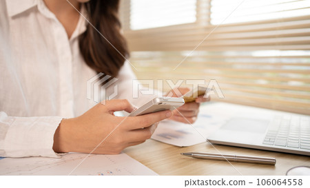 Women use smart phone to register online purchases using credit card payments, Technology for the use of smartphones for business or online financial transactions, Shopping online concept. 106064558