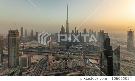 Panorama showing aerial view of tallest towers in Dubai Downtown skyline and highway timelapse. Panorama showing aerial view of tallest towers in Dubai Downtown skyline and highway timelapse. 106065034
