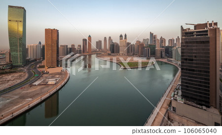 Cityscape of skyscrapers in Dubai Business Bay with water canal aerial night to day timelapse Cityscape of skyscrapers in Dubai Business Bay with water canal aerial night to day timelapse 106065040