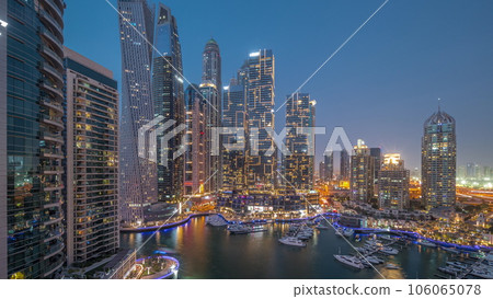 Dubai marina tallest skyscrapers and yachts in harbor aerial day to night timelapse. 106065078