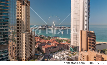Panoramic view of the Dubai Marina and JBR area and the famous Ferris Wheel aerial timelapse Panoramic view of the Dubai Marina and JBR area and the famous Ferris Wheel aerial timelapse 106065112
