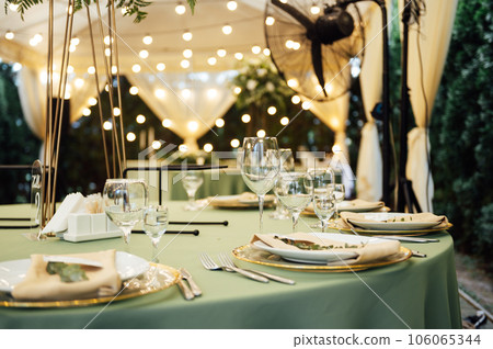 Open air wedding restaurant decorated with fresh flowers and premium dishes Open air wedding restaurant decorated with fresh flowers and premium dishes 106065344