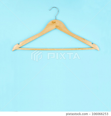 The Cloth hanger made from wooden on blue background with empty space for your design. The Cloth hanger made from wooden on blue background with empty space for your design. 106066253