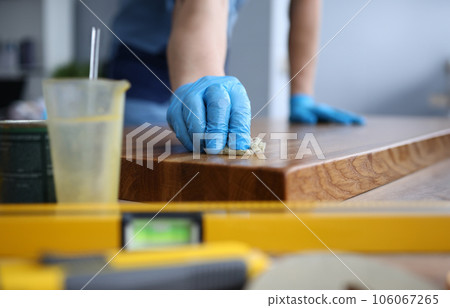 Carpenter apply paint on ground 106067265