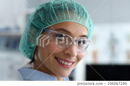 Close-up girl doctor in protective clothes smiling 106067290