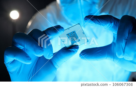 Close-up gloved hands holding detail microchip 106067308