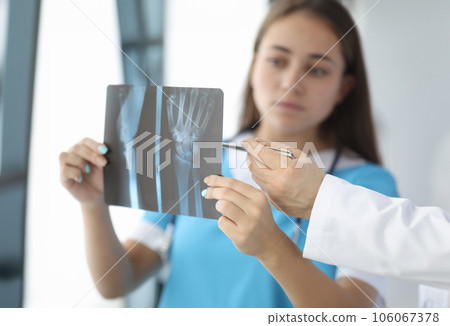 Doctor discussing x-ray of patient Doctor discussing x-ray of patient 106067378