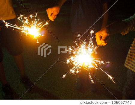 Children enjoying handheld fireworks Children enjoying handheld fireworks 106067743