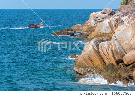 Traveling on long-tail boat along rocky sea shore of Ko Lipe island, Thailand 106067863