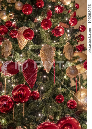 New Year's toys on a Christmas tree with lights. Christmas blurred background New Year's toys on a Christmas tree with lights. Christmas blurred background 106068068