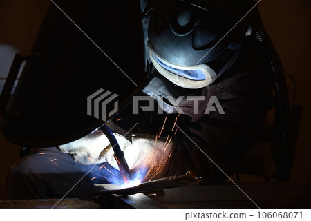 welder is welding metal part in car factory welder is welding metal part in car factory 106068071
