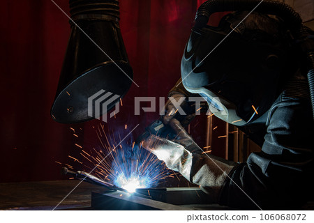 welder is welding metal part in car factory welder is welding metal part in car factory 106068072