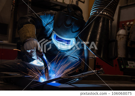 welder is welding metal part in car factory welder is welding metal part in car factory 106068075