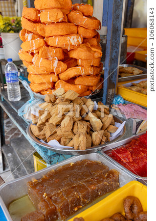 Delicious snacks and sweets at a street food stall in Asia Delicious snacks and sweets at a street food stall in Asia 106068143