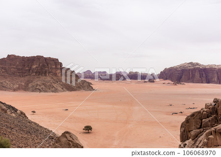 Planet Mars like landscape - Photo of Wadi Rum desert in Jordan with red pink sky above, this location was used as set for many science fiction movies 106068970