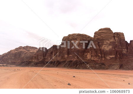 Planet Mars like landscape - Photo of Wadi Rum desert in Jordan with red pink sky above, this location was used as set for many science fiction movies Planet Mars like landscape - Photo of Wadi Rum desert in Jordan with red pink sky above, this location was used as set for many science fiction movies 106068973