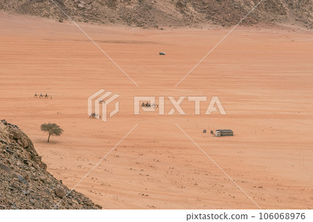 Planet Mars like landscape - Photo of Wadi Rum desert in Jordan with red pink sky above, this location was used as set for many science fiction movies Planet Mars like landscape - Photo of Wadi Rum desert in Jordan with red pink sky above, this location was used as set for many science fiction movies 106068976